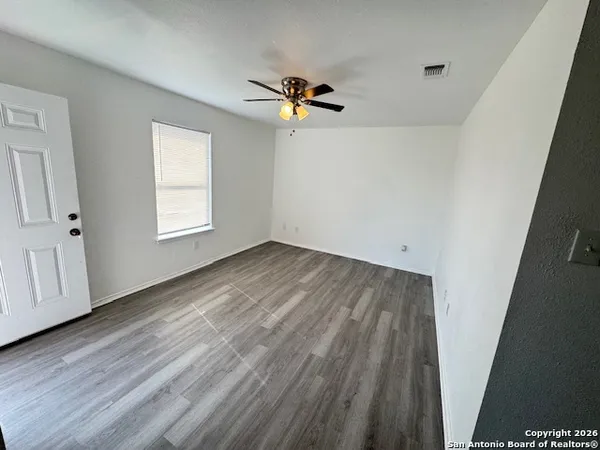 wooden floor in an empty room with a window