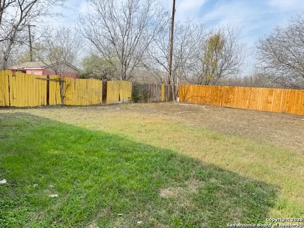 a view of big yard with large trees