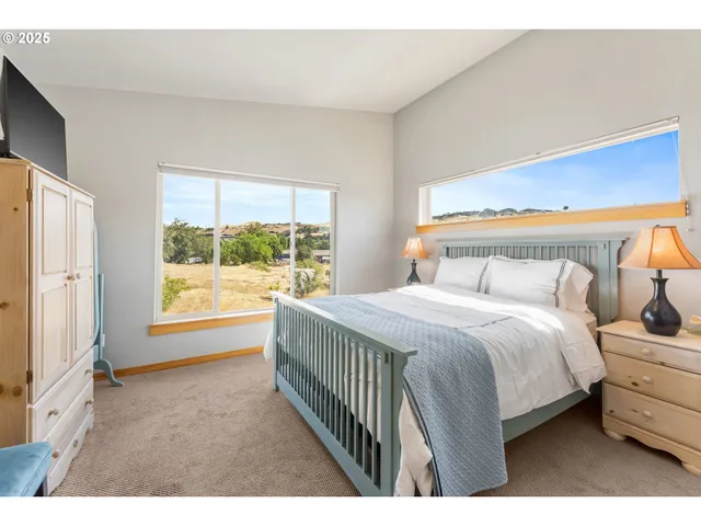 a bedroom with a large bed and a window