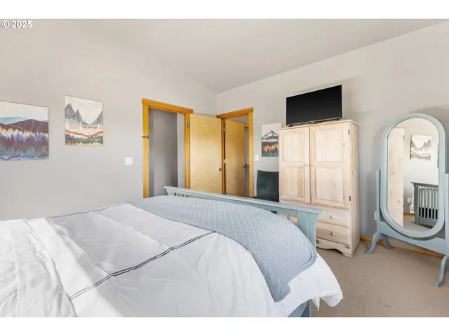 a bedroom with a bed and cabinets