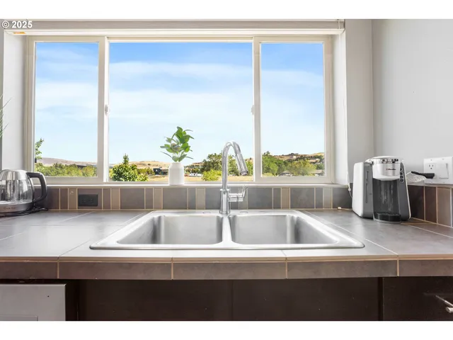 a kitchen with a sink a stove and cabinets