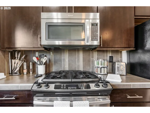 a bathroom with a granite countertop toilet a sink and a mirror