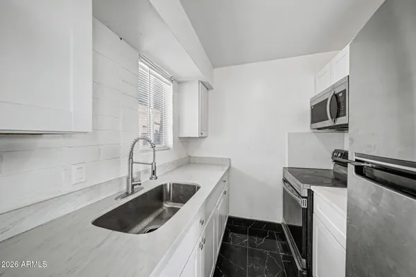 a kitchen that has a sink and a stove