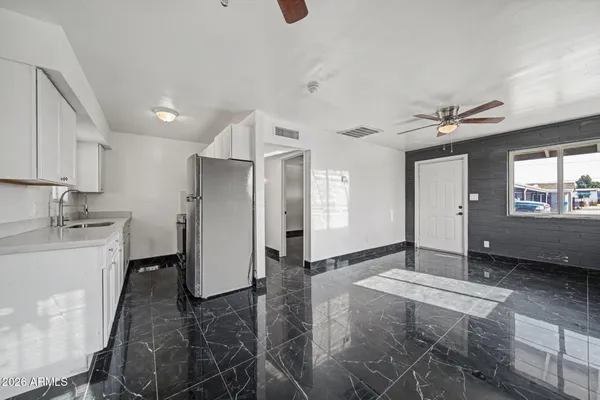 a living room with stainless steel appliances kitchen island furniture and a window