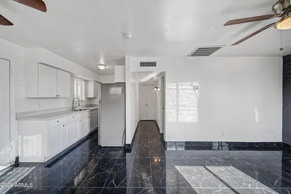 a kitchen with stainless steel appliances granite countertop a refrigerator and a stove