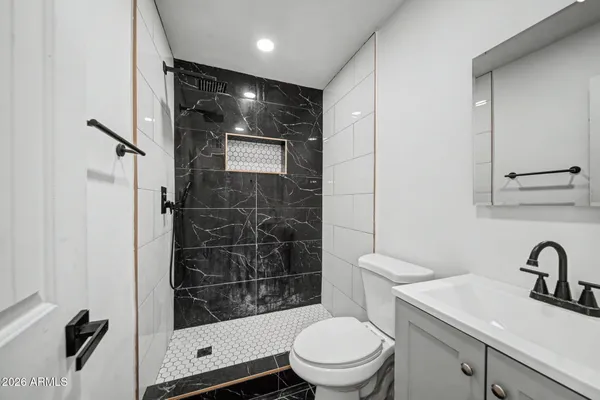 a bathroom with a toilet a sink and shower