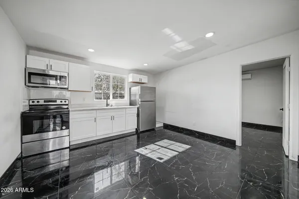 a kitchen with stainless steel appliances a refrigerator and a stove top oven