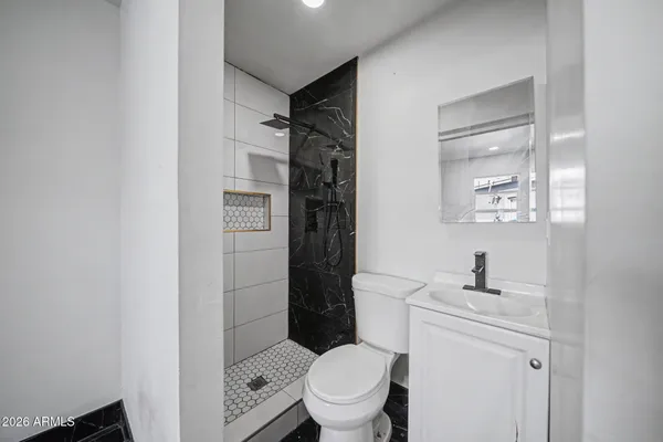 a white toilet sitting next to a bathroom sink