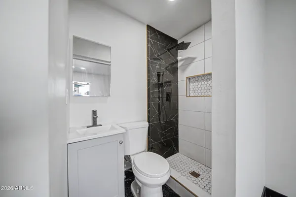 a bathroom with a toilet sink and shower