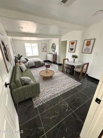 a living room with furniture and wooden floor