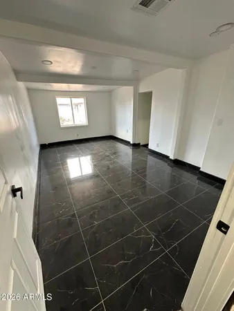 a view of a livingroom with an empty space and a window