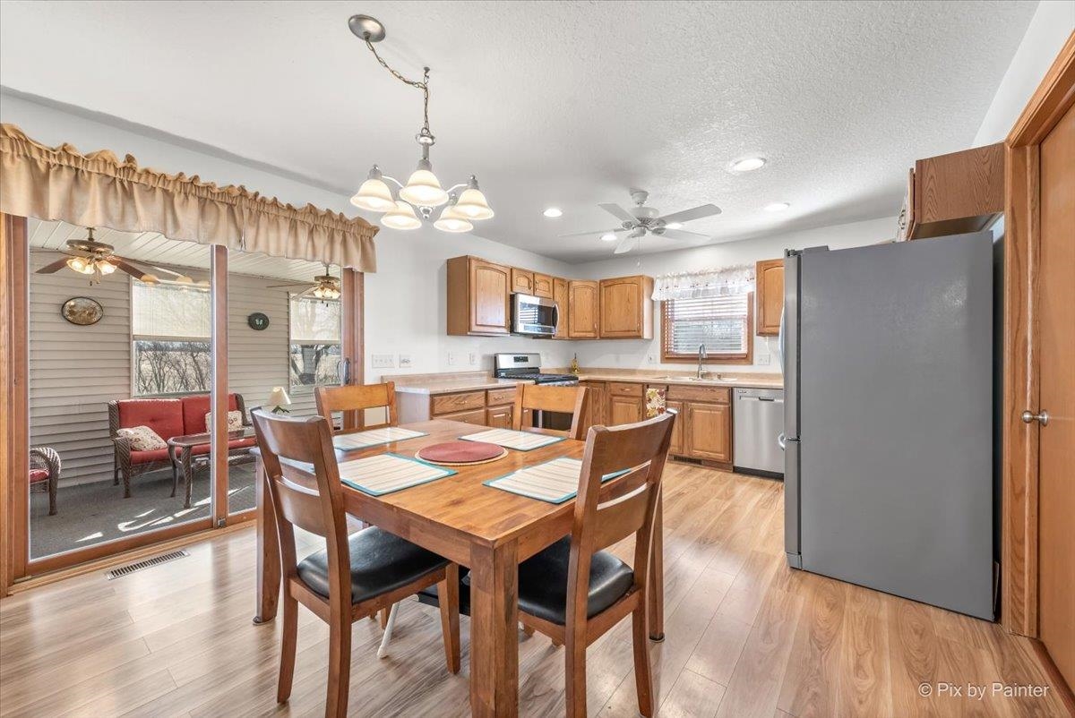 19-14 Timber Ridge Road Lanark, IL 61046 - Photo 6 of 55 a dining room filled chandelier and wooden floor
