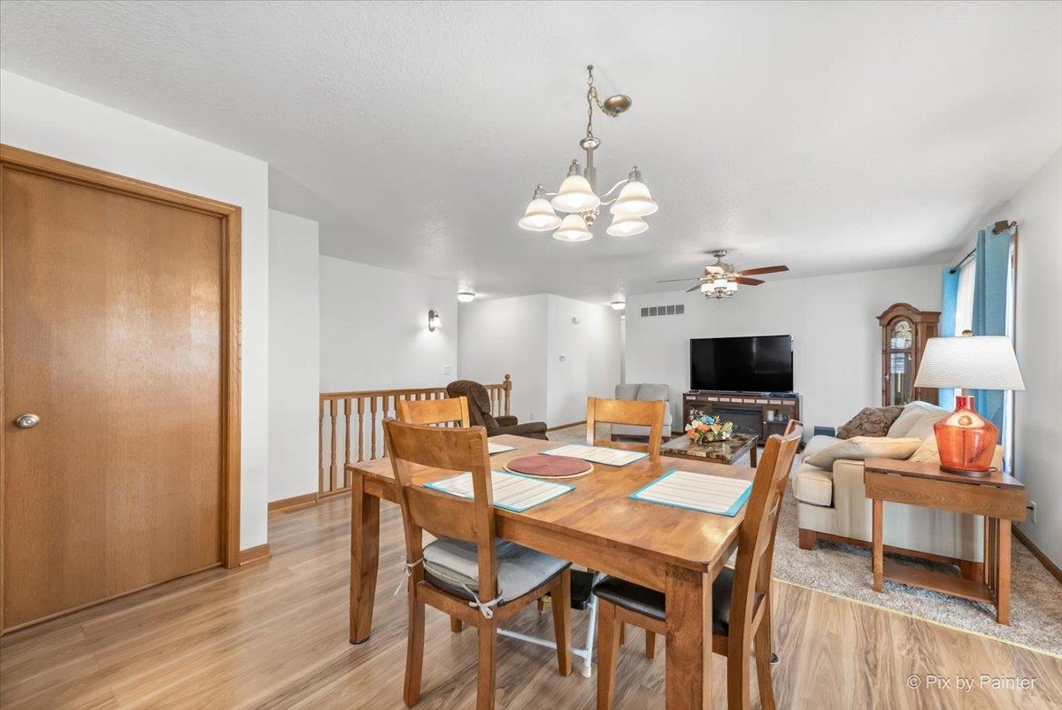 19-14 Timber Ridge Road Lanark, IL 61046 - Photo 7 of 55 a view of a dining room with furniture and wooden floor