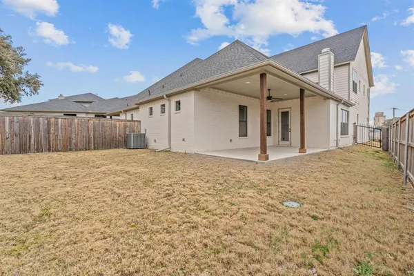 a view of a house with wooden fence