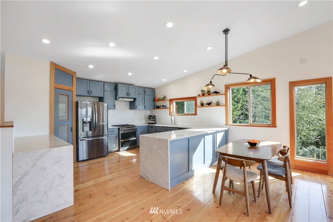 28740 Bacus Road Sedro-Woolley, WA 98284 - Photo 13 of 40 a open kitchen with stainless steel appliances granite countertop a table chairs and a refrigerator