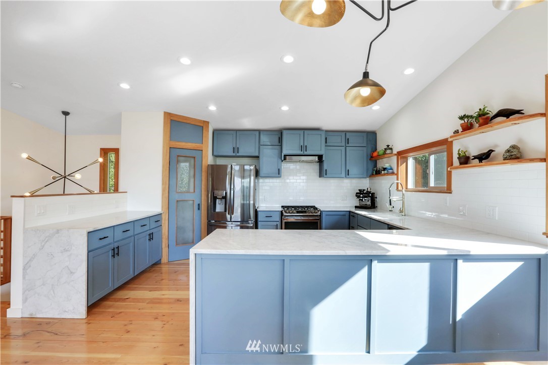 28740 Bacus Road Sedro-Woolley, WA 98284 - Photo 14 of 40 a kitchen with granite countertop a center island a sink stainless steel appliances and cabinets