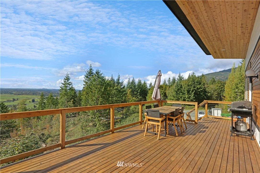 28740 Bacus Road Sedro-Woolley, WA 98284 - Photo 33 of 40 a view of a balcony with chairs and wooden floor