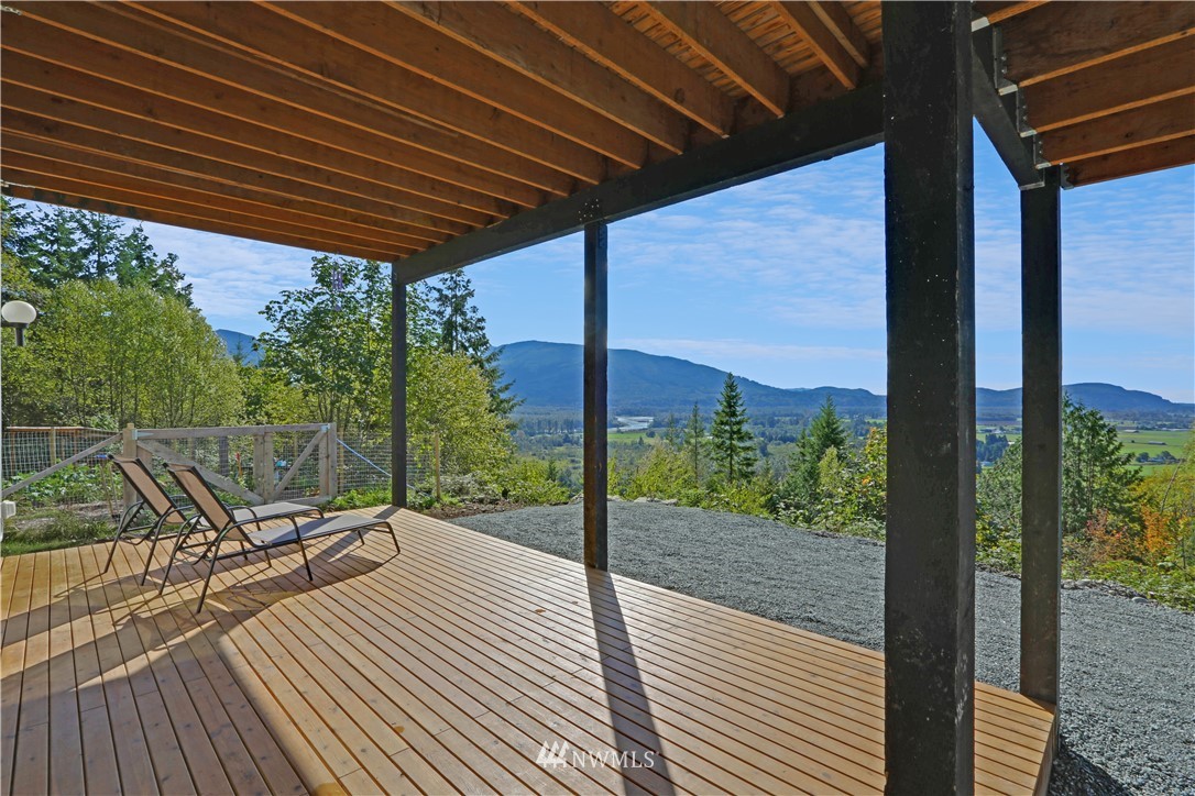 28740 Bacus Road Sedro-Woolley, WA 98284 - Photo 35 of 40 a view of a patio with a table chairs and wooden floor