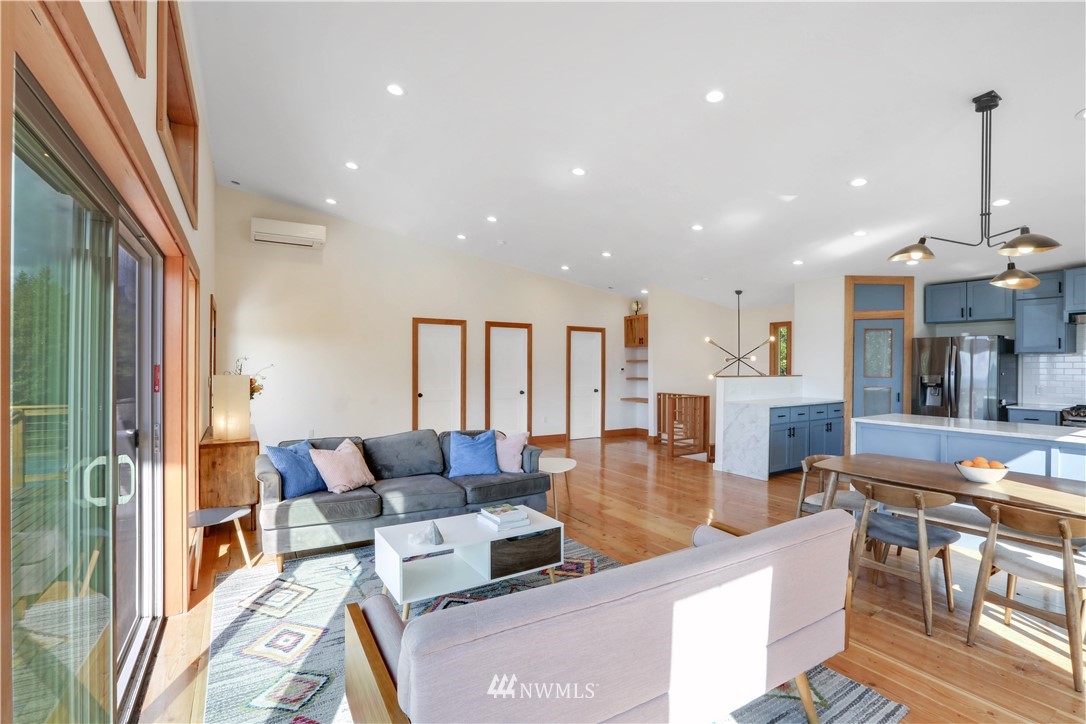 28740 Bacus Road Sedro-Woolley, WA 98284 - Photo 9 of 40 a living room with fireplace furniture and a chandelier