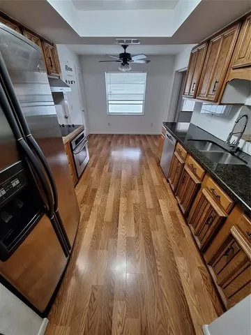 a view of an empty room with wooden floor