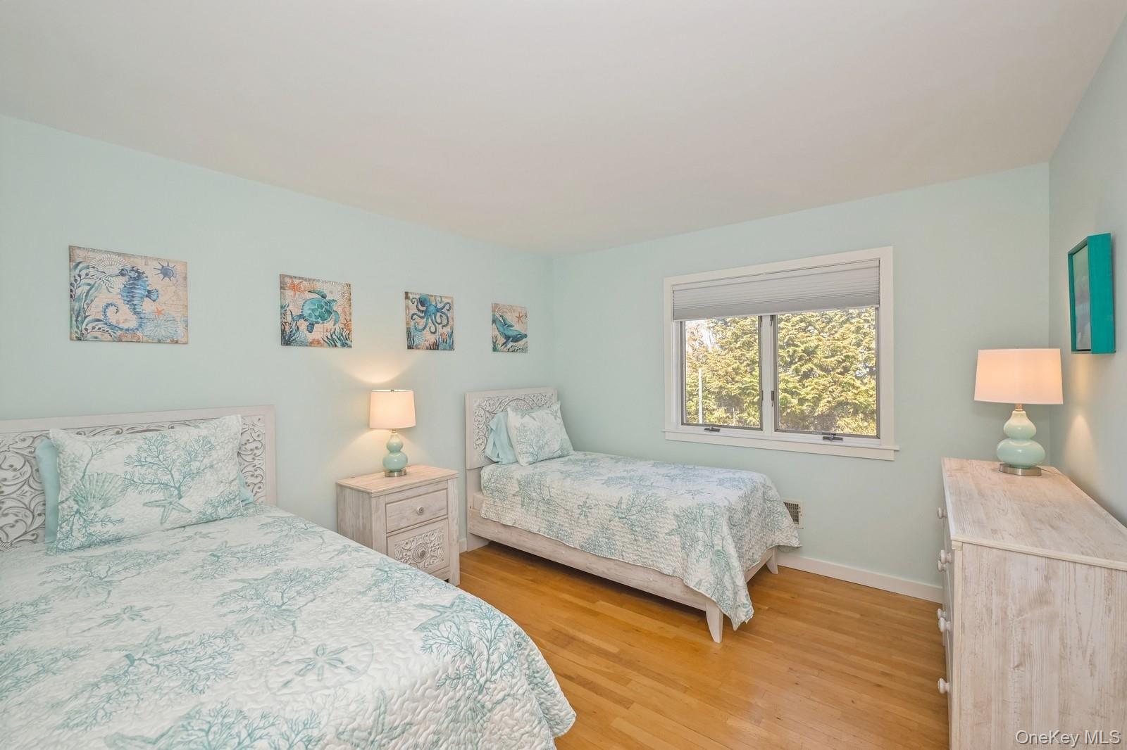 16 Hildreth Road Hampton Bays, NY 11946 - Photo 24 of 29 a bedroom with two beds and a window