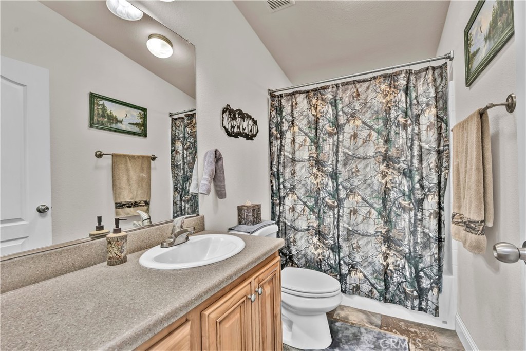 14986 Western Mine Road Middletown, CA 95461 - Photo 16 of 60 a bathroom with a granite countertop sink and a mirror