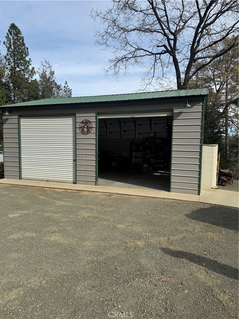 14986 Western Mine Road Middletown, CA 95461 - Photo 55 of 60 a front view of a house with a yard and garage