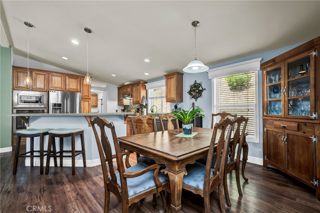 14986 Western Mine Road Middletown, CA 95461 - Photo 9 of 60 a dining room with wooden floor a chandelier a wooden table and chairs