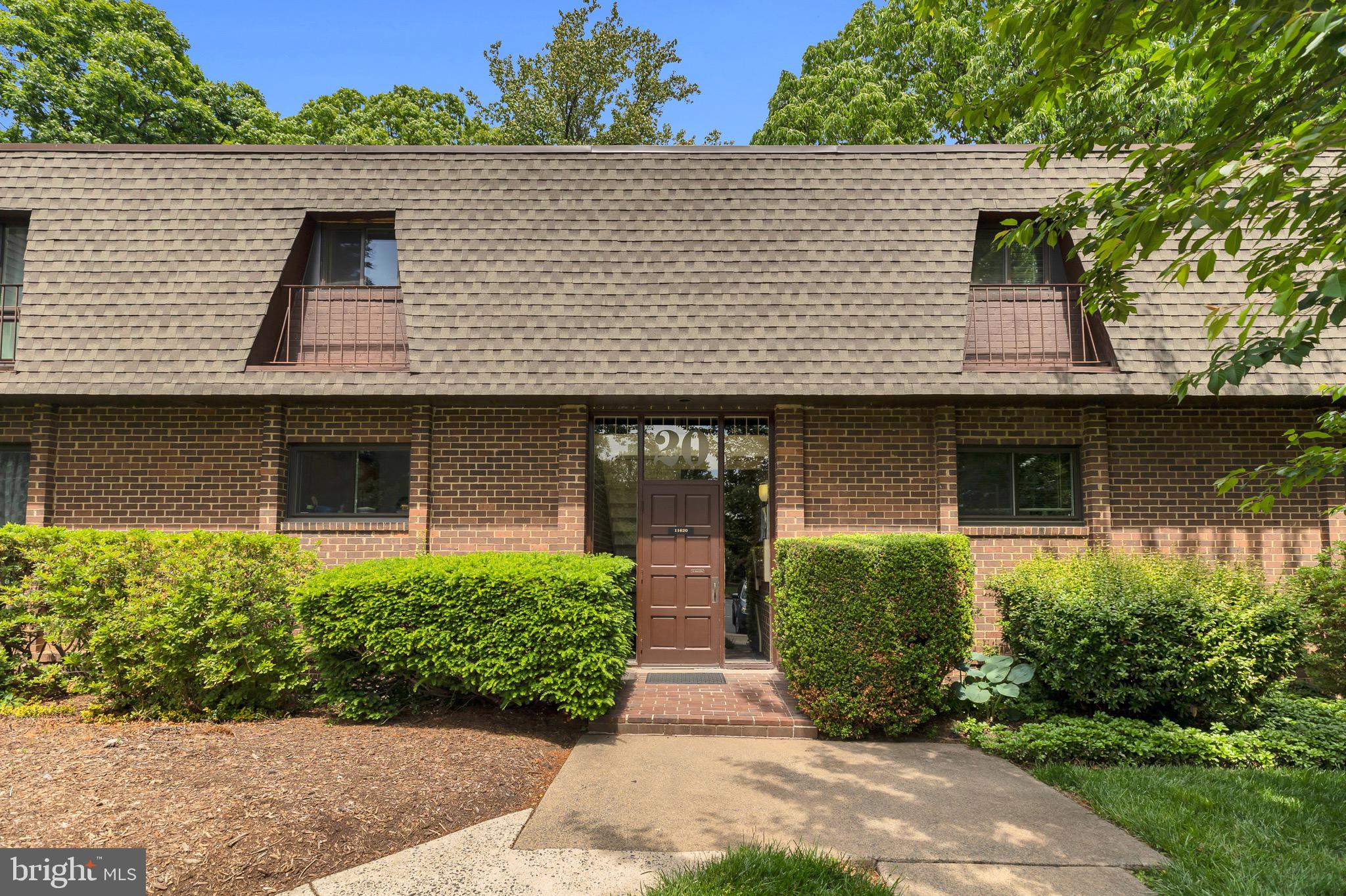 11620 Vantage Hill Road, Unit 22B Reston, VA 20190 - Photo 3 of 24 a front view of a house with garden