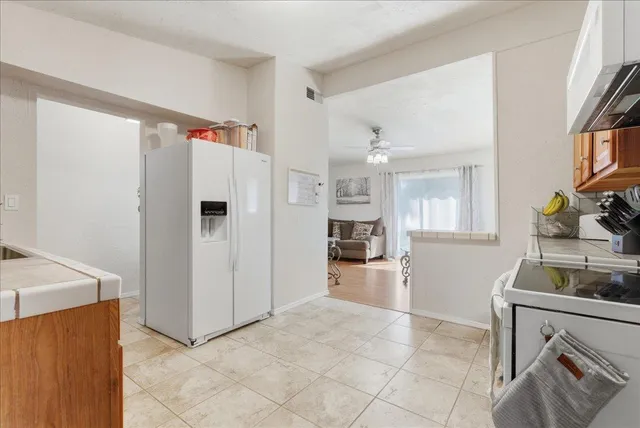 a kitchen with refrigerator and cabinets