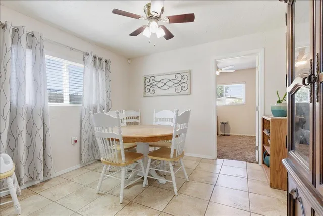 a dining room with furniture and window
