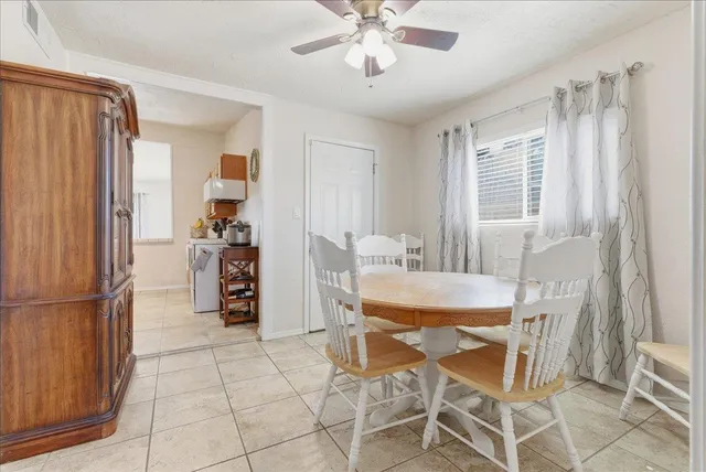 a dining room with furniture and window