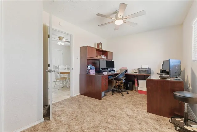 a view of a workspace with furniture and a workspace