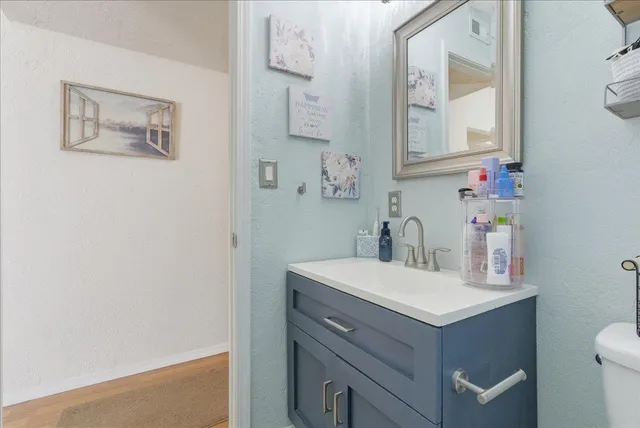 a bathroom with a sink vanity and a mirror