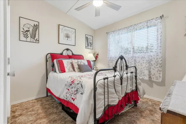 a bedroom with bed and the view of bathroom