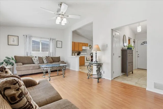 a living room with furniture and a wooden floor