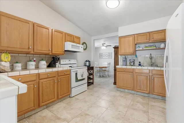 a kitchen with cabinets appliances and a window