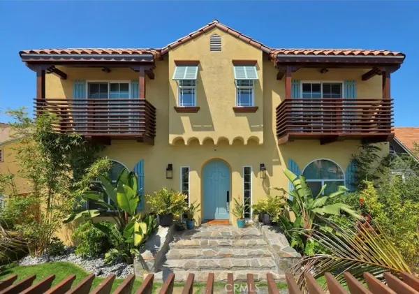 a front view of a house with fountain
