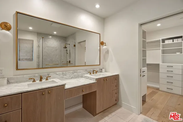 a bathroom with a granite countertop sink mirror and double