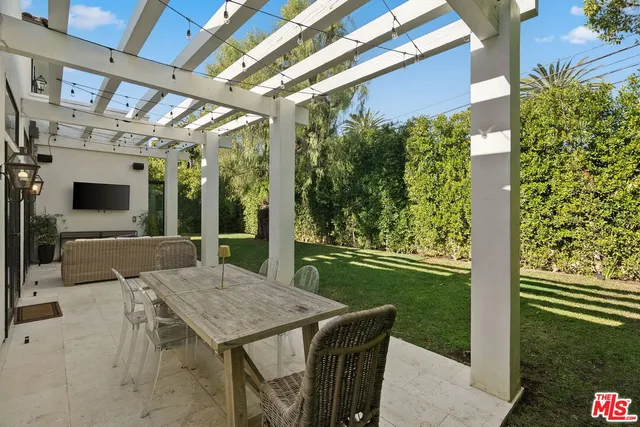 a view of a patio with a table and chairs
