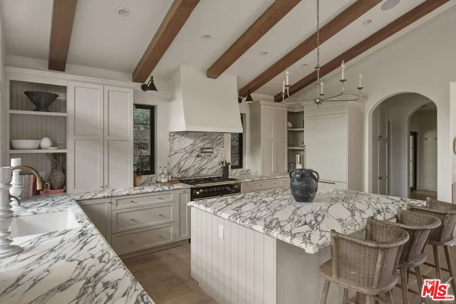 a kitchen with stainless steel appliances kitchen island granite countertop a sink stove and cabinets