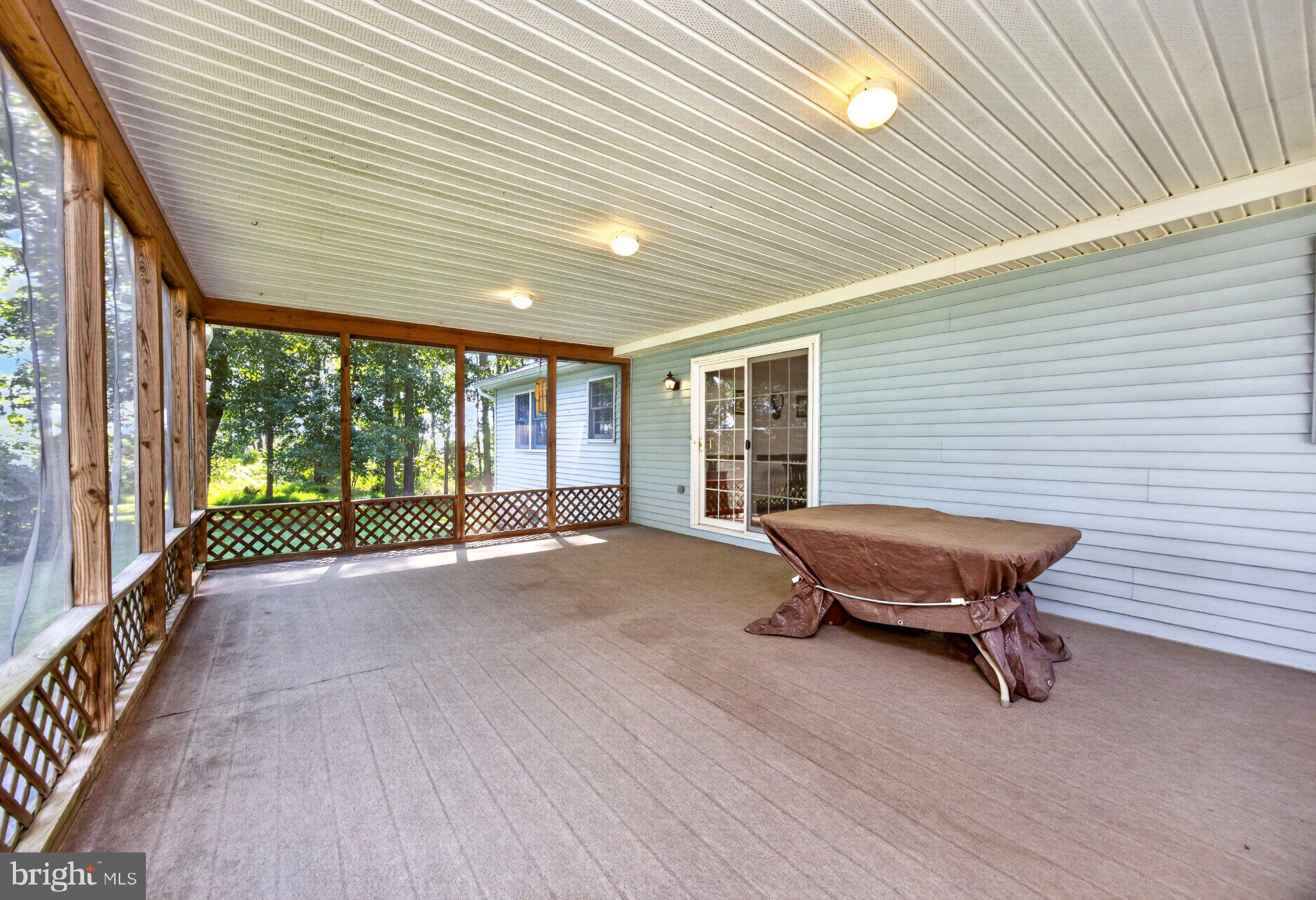 725 Ewing Road Cochranville, PA 19330 - Photo 12 of 55 Screened in porch off the kitchen