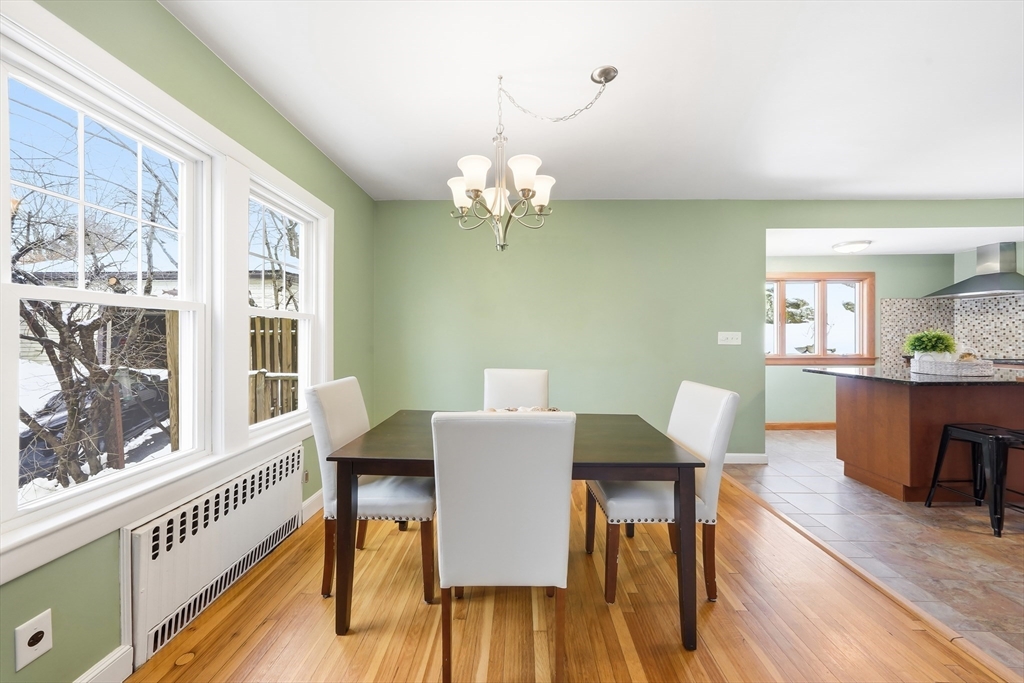 112 Ashcroft Road Medford, MA 02155 - Photo 11 of 42 a view of a dining room with furniture a chandelier and wooden floor