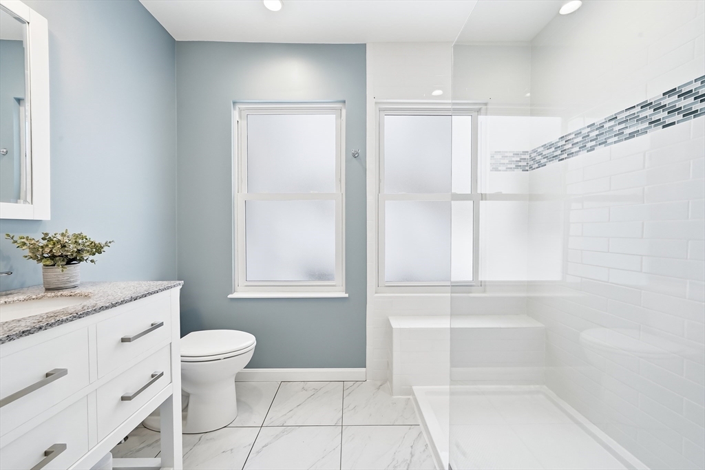 112 Ashcroft Road Medford, MA 02155 - Photo 27 of 42 a bathroom with a granite countertop sink a toilet and shower