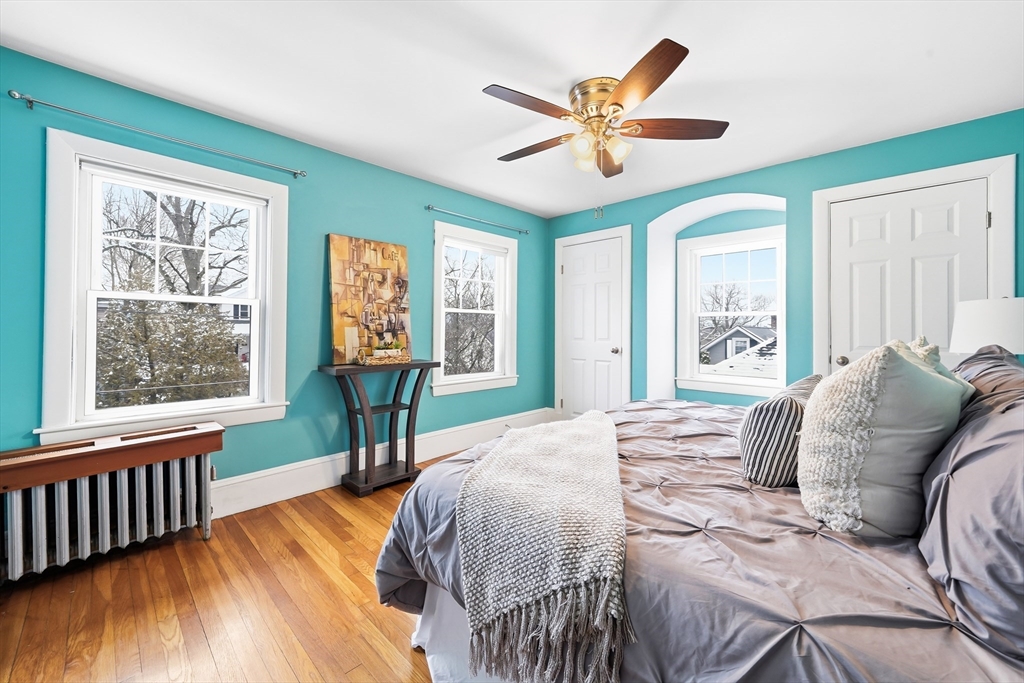 112 Ashcroft Road Medford, MA 02155 - Photo 29 of 42 a bedroom with a bed and a chandelier