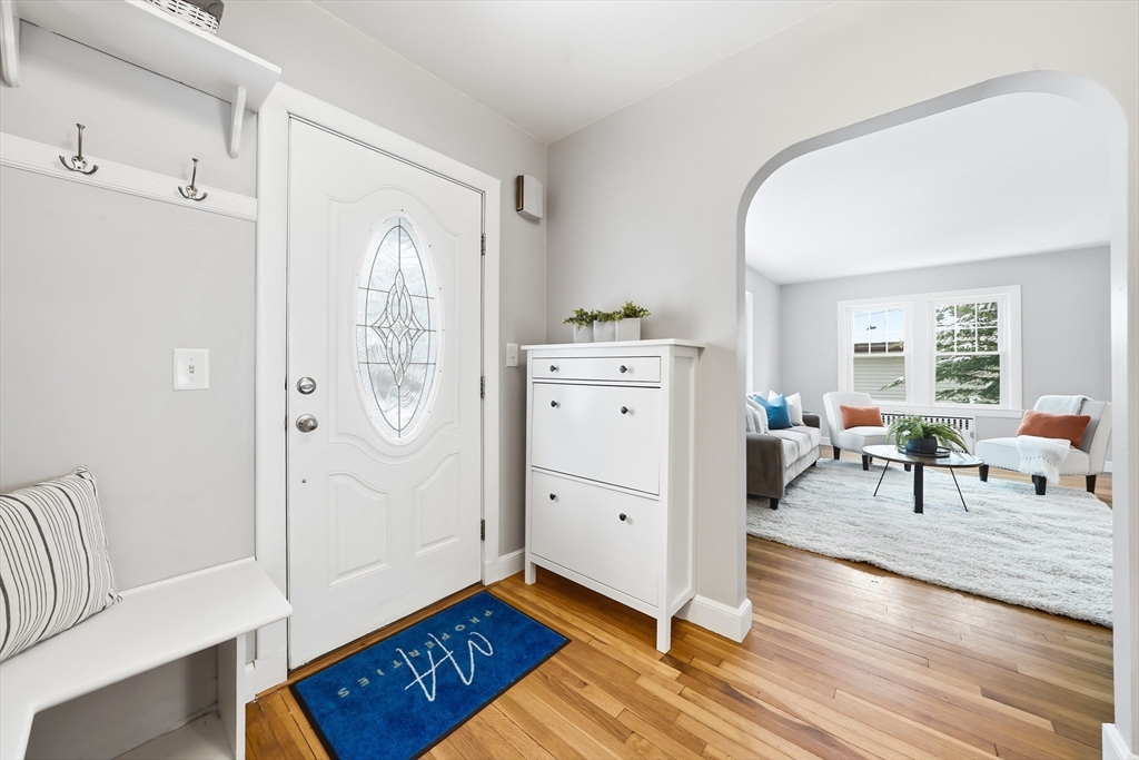 112 Ashcroft Road Medford, MA 02155 - Photo 3 of 42 a view of a livingroom with wooden floor and a fireplace