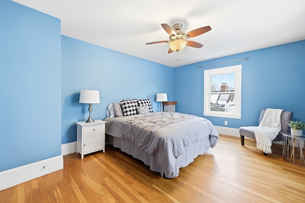 112 Ashcroft Road Medford, MA 02155 - Photo 34 of 42 a bedroom with a bed and a chandelier