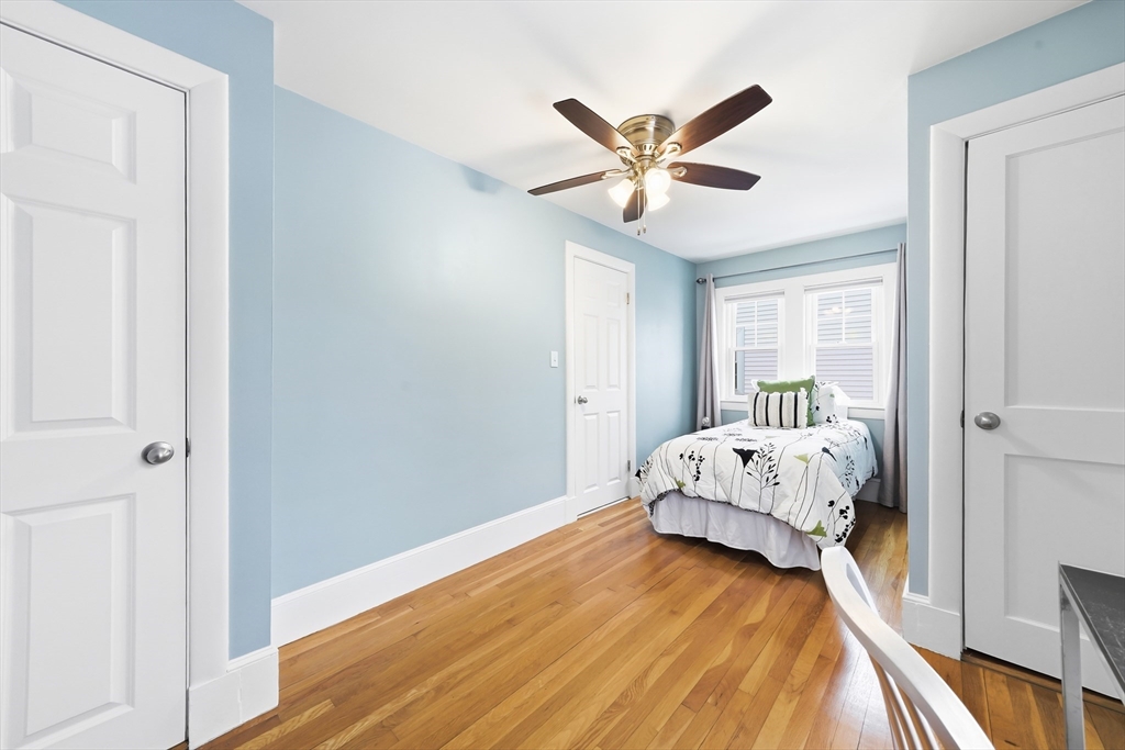 112 Ashcroft Road Medford, MA 02155 - Photo 37 of 42 a bedroom with a bed and wooden floor