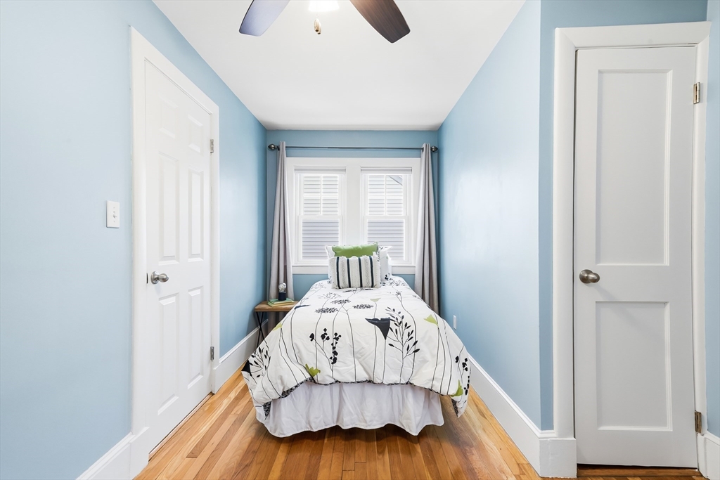 112 Ashcroft Road Medford, MA 02155 - Photo 38 of 42 a bedroom with a bed and a chandelier
