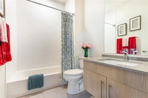 a bathroom with a sink a toilet and a shower